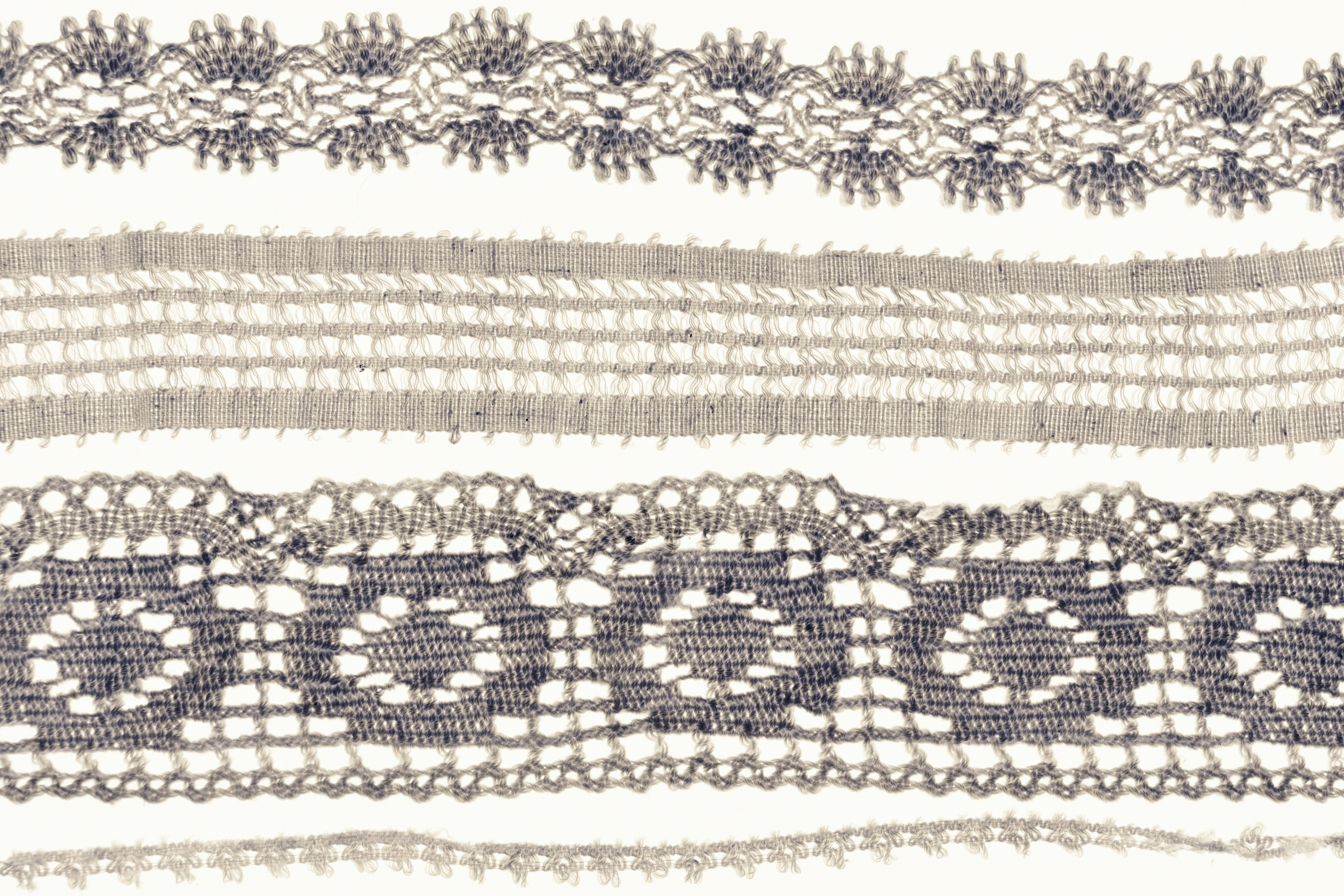 Vintage lace and trim laid on white, delicate neutral tones